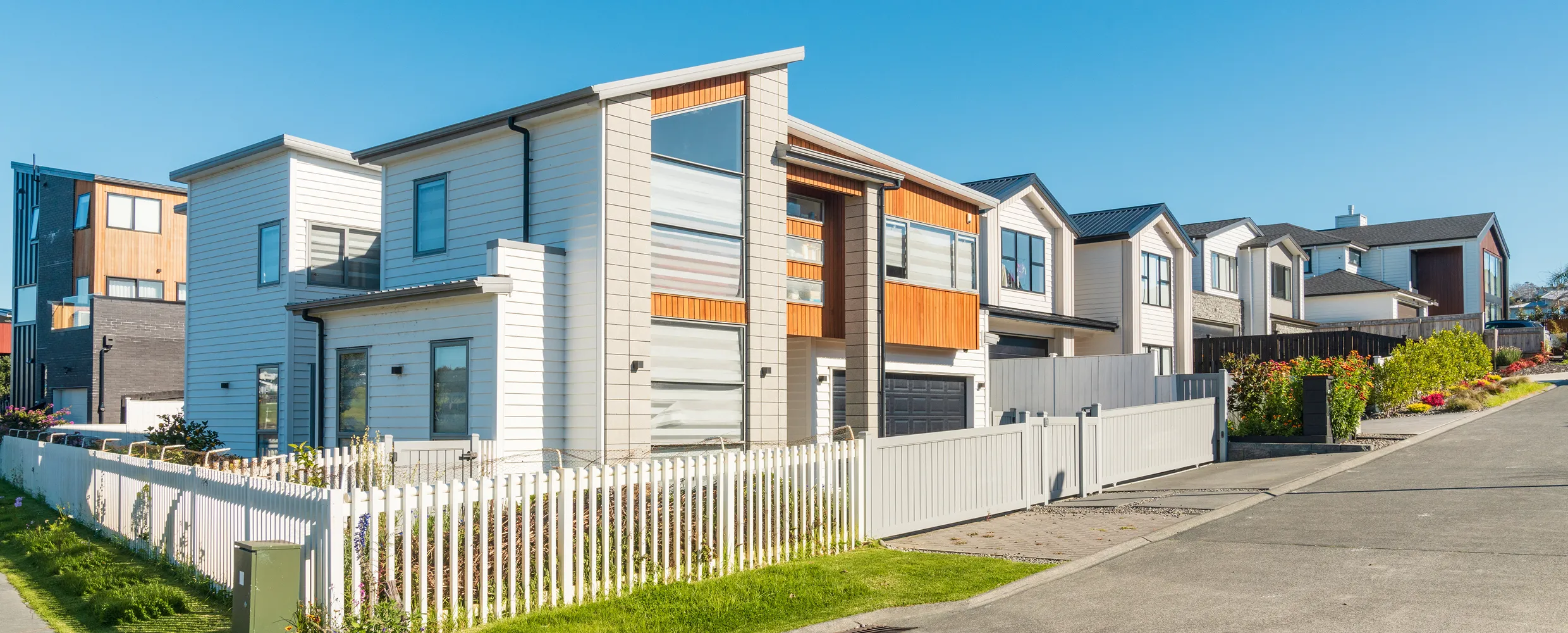 Modern suburban houses with white fences